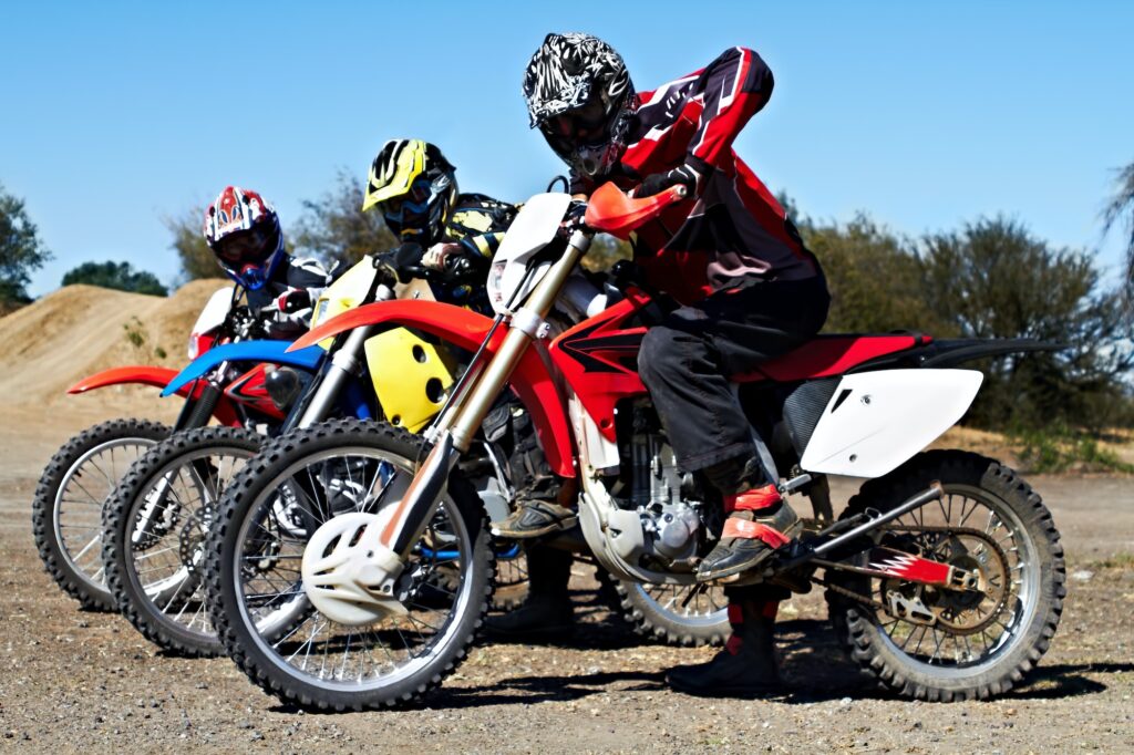 Showing off their wheels. Three bikers sitting on their motorcycles ready for a race.